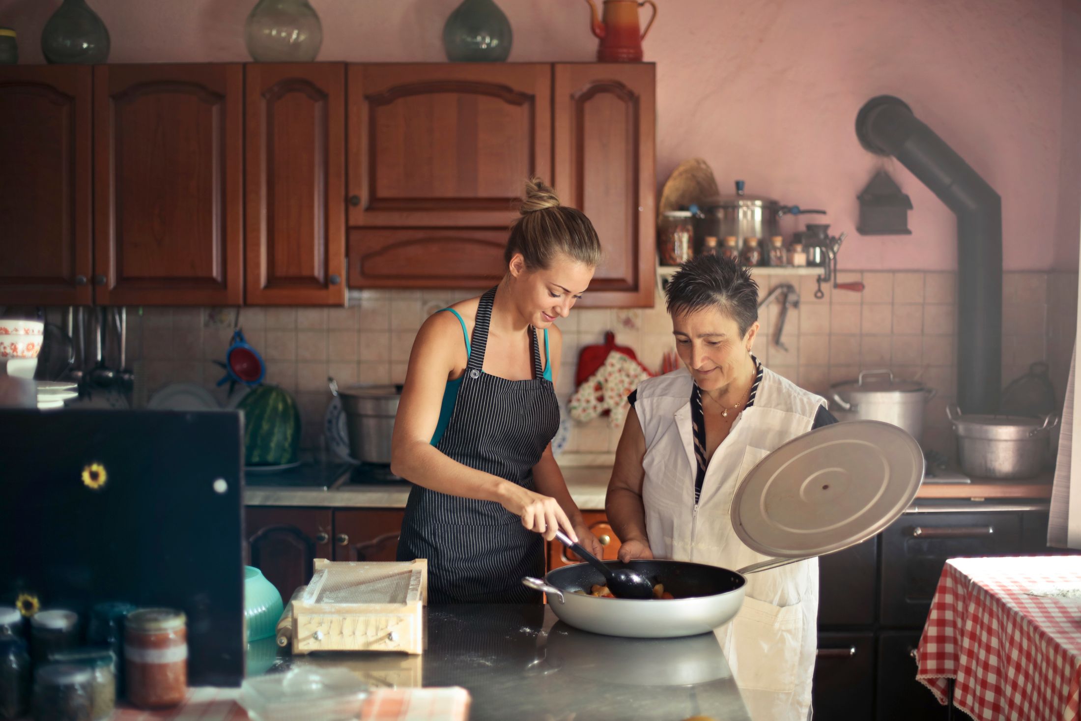 Two women preparing a meal together at home; illustrative photo